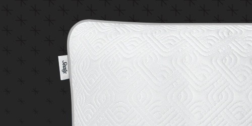 A detail shot of one Sealy Adjustable pillow corner, with the Sealy tag visible, mobile view